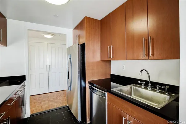 a kitchen with a sink and a refrigerator