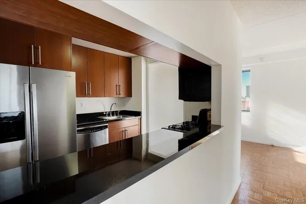 a kitchen with a refrigerator and a sink