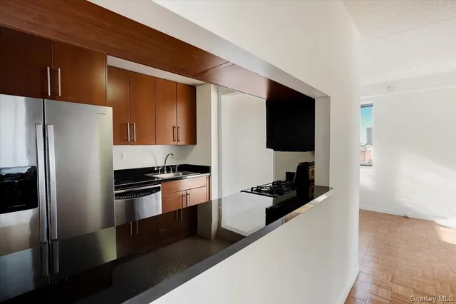 a kitchen with a refrigerator and a sink