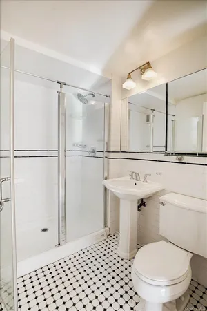 a bathroom with a sink toilet vanity and shower
