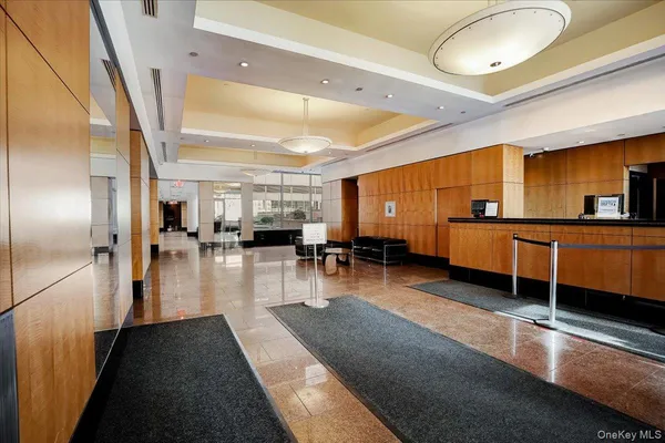 a lobby with furniture and a large window