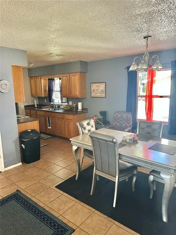 a kitchen with a table chairs and wooden floor