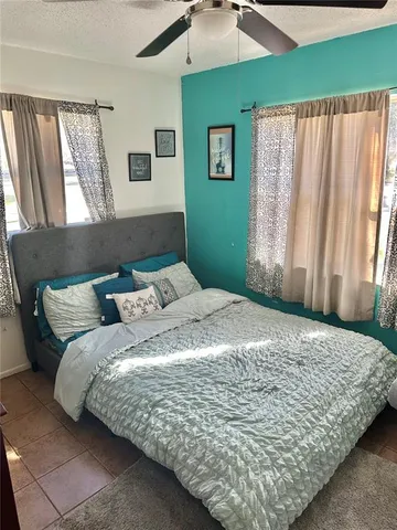 a bed sitting in a bedroom next to a window