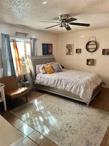 a bedroom with a bed and a couch