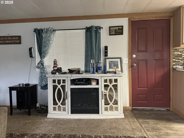 a kitchen with a table chairs refrigerator and cabinets