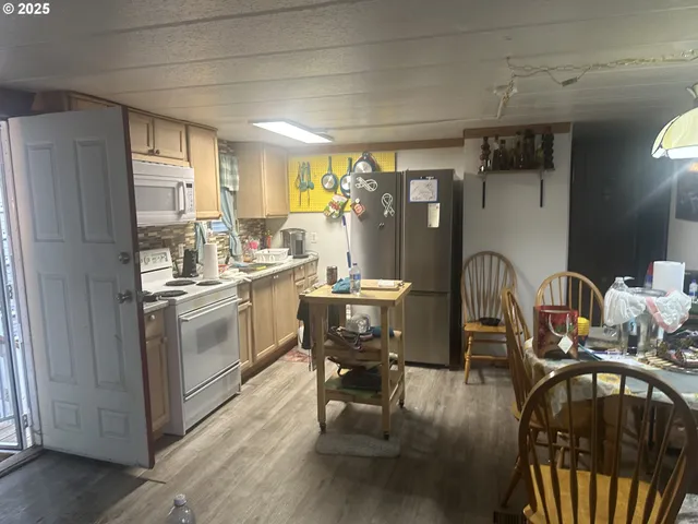 a stove top oven sitting inside of a kitchen