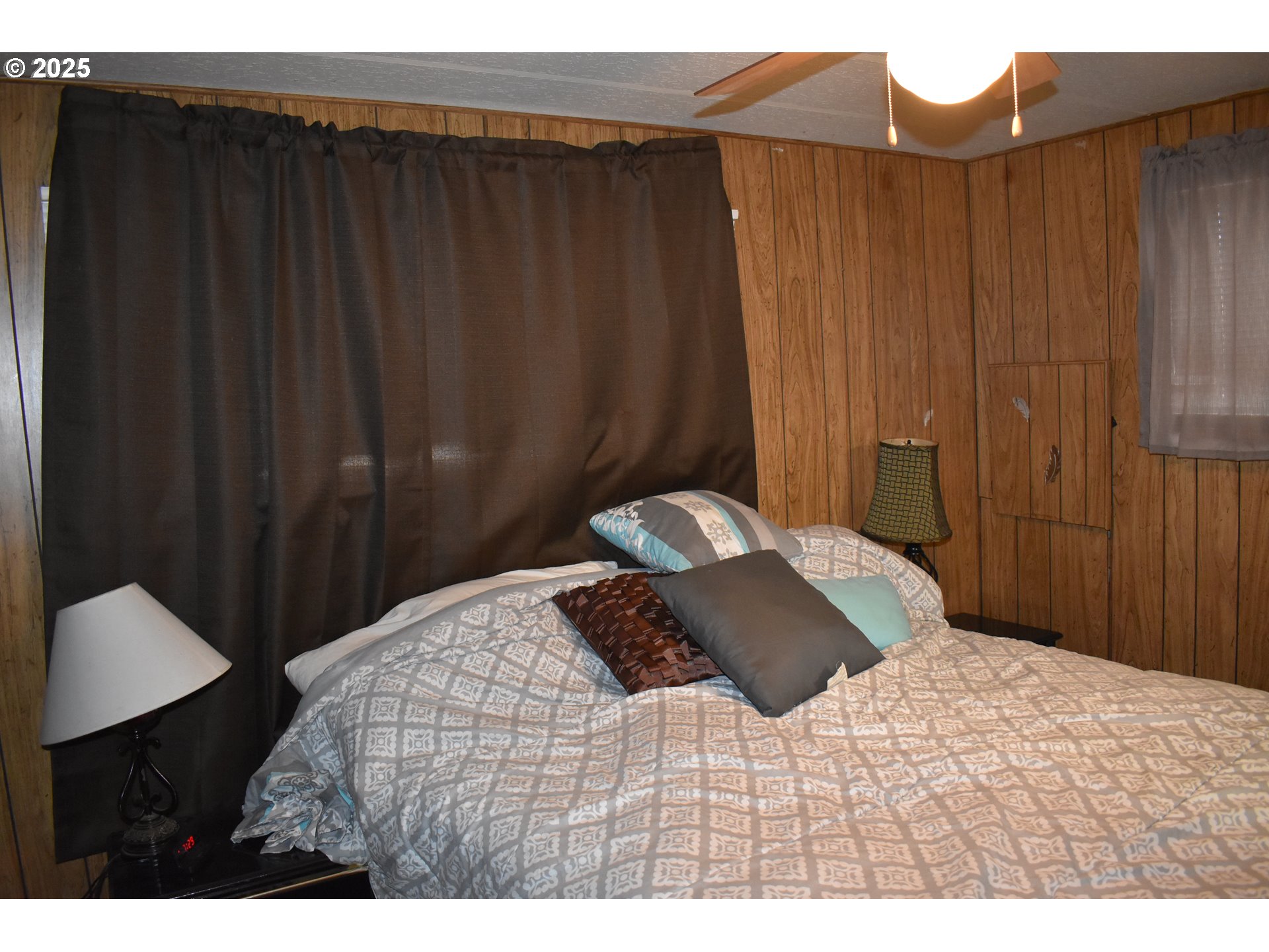 125 North 4th Street Lakeside, OR 97449 - Photo 17 of 39 a bedroom with a bed and a cabinet