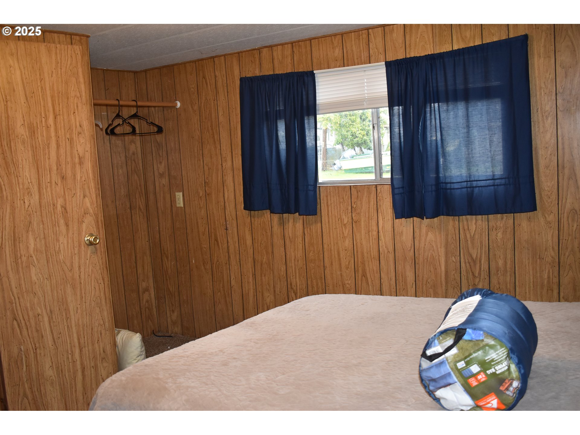 125 North 4th Street Lakeside, OR 97449 - Photo 19 of 39 a bedroom with a bed and a window