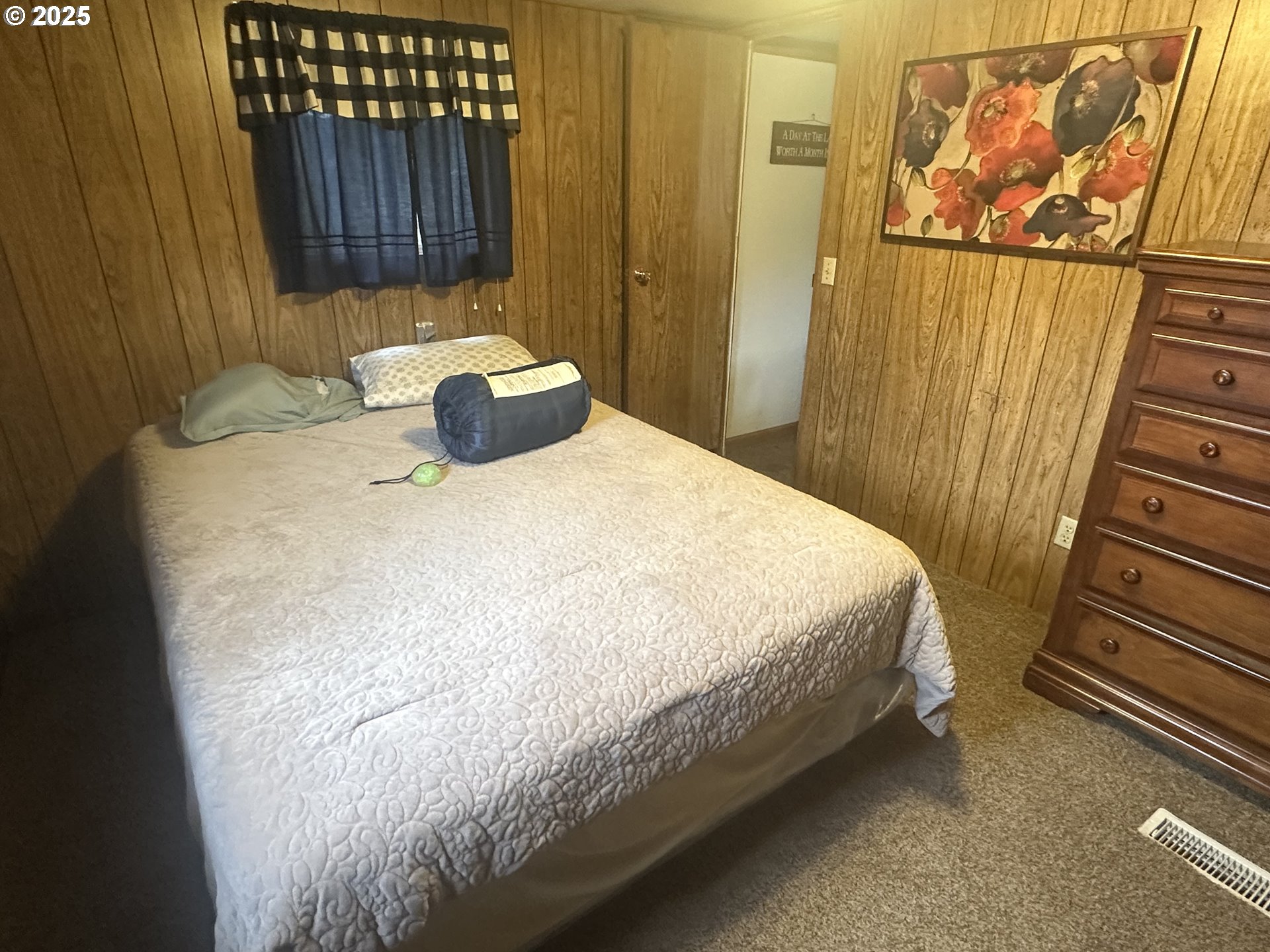 125 North 4th Street Lakeside, OR 97449 - Photo 20 of 39 a bed sitting in a bathroom next to a wooden wall