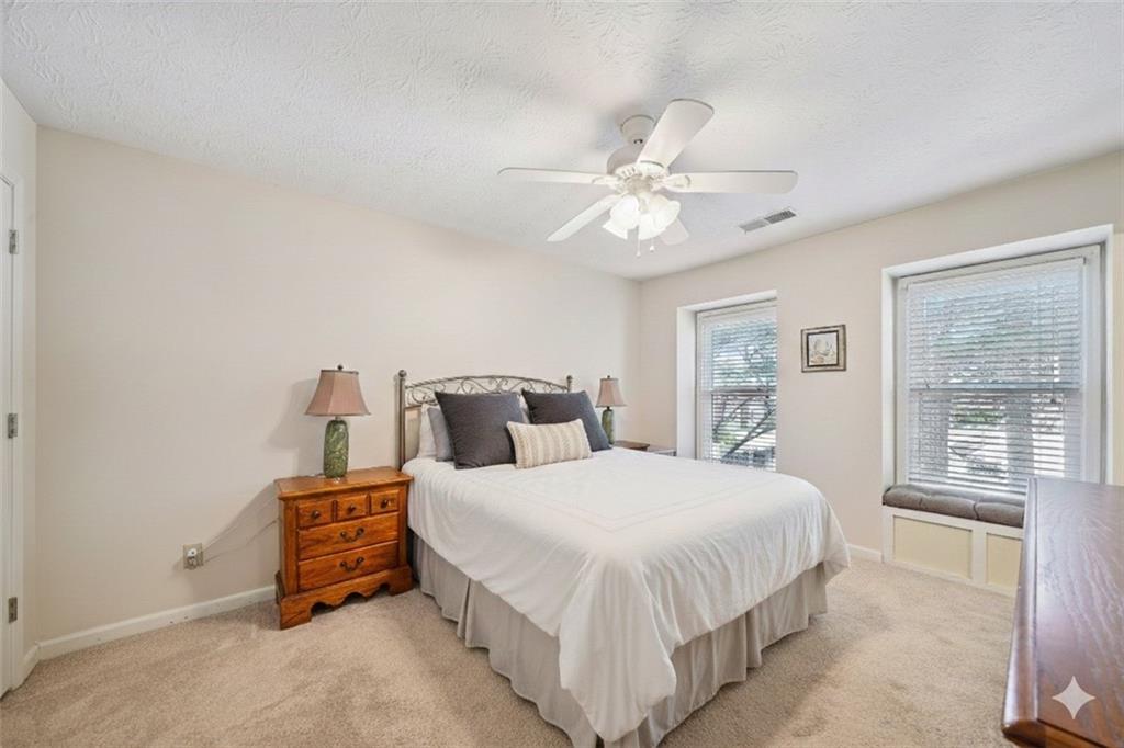 4166 Oakwood Way Duluth, GA 30096 - Photo 12 of 28 a bedroom with a bed chandelier and a window