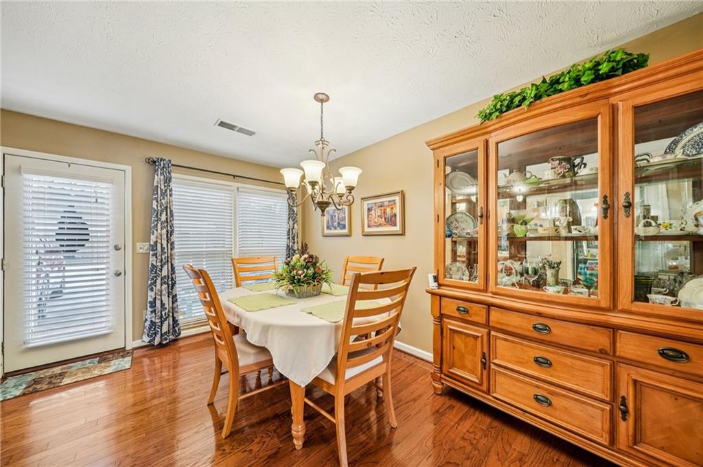 4166 Oakwood Way Duluth, GA 30096 - Photo 4 of 28 a view of a dining room with furniture window and wooden floor