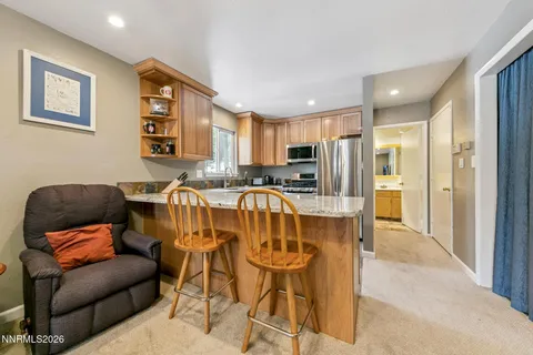 a living room with furniture a flat screen tv and a chandelier