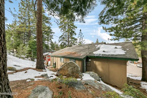 a view of a house with a snow in the background