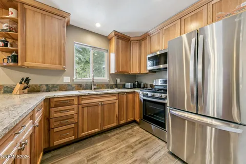 a view of a room with wooden floor
