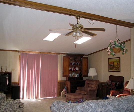 154 Great Road, Unit 4 Shirley, MA 01464 - Photo 3 of 16 a living room with furniture a chandelier and a window