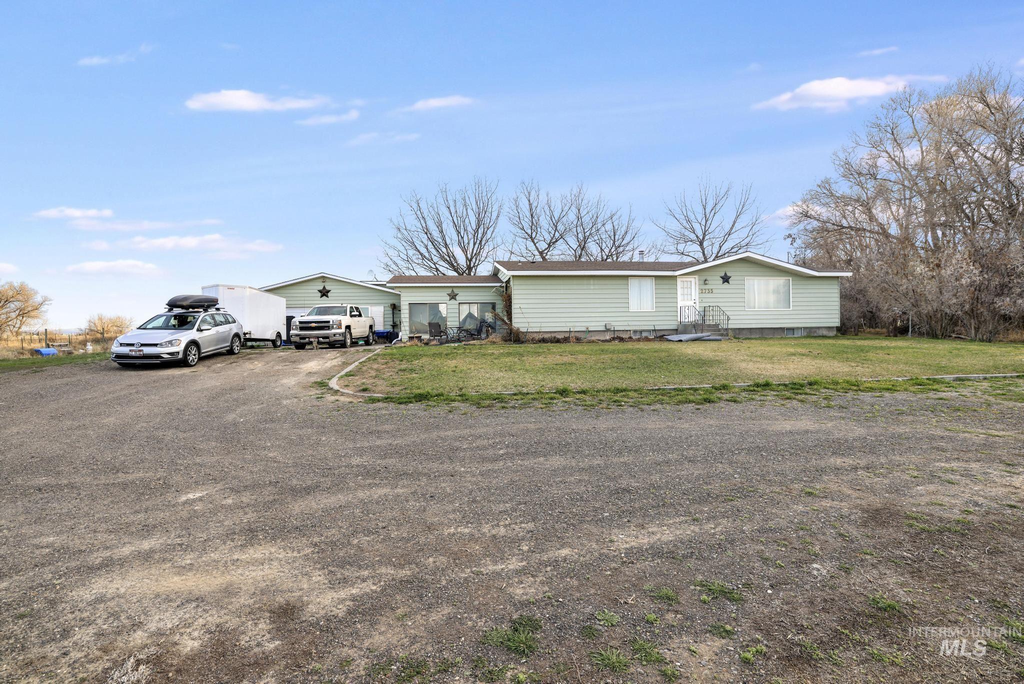 View of front of home with a front yard and driveway