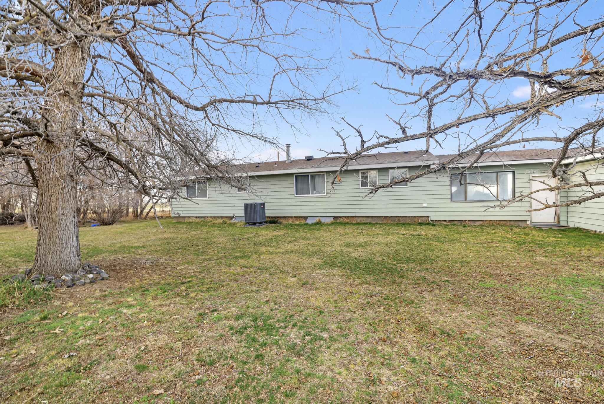2735 East 3300 N Road Twin Falls, ID 83301 - Photo 6 of 24 Back of house featuring a lawn