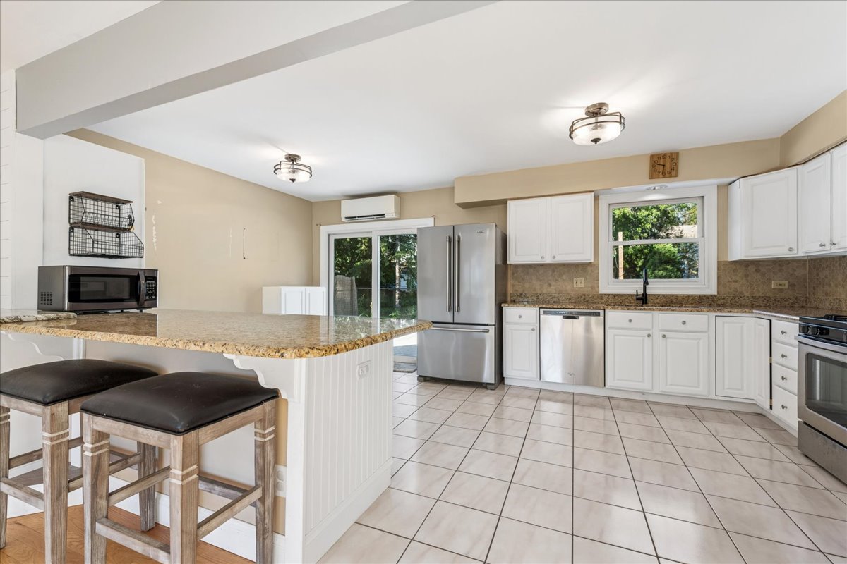 208 South River Road Fox River Grove, IL 60021 - Photo 6 of 40 a kitchen with a stove a sink and a refrigerator