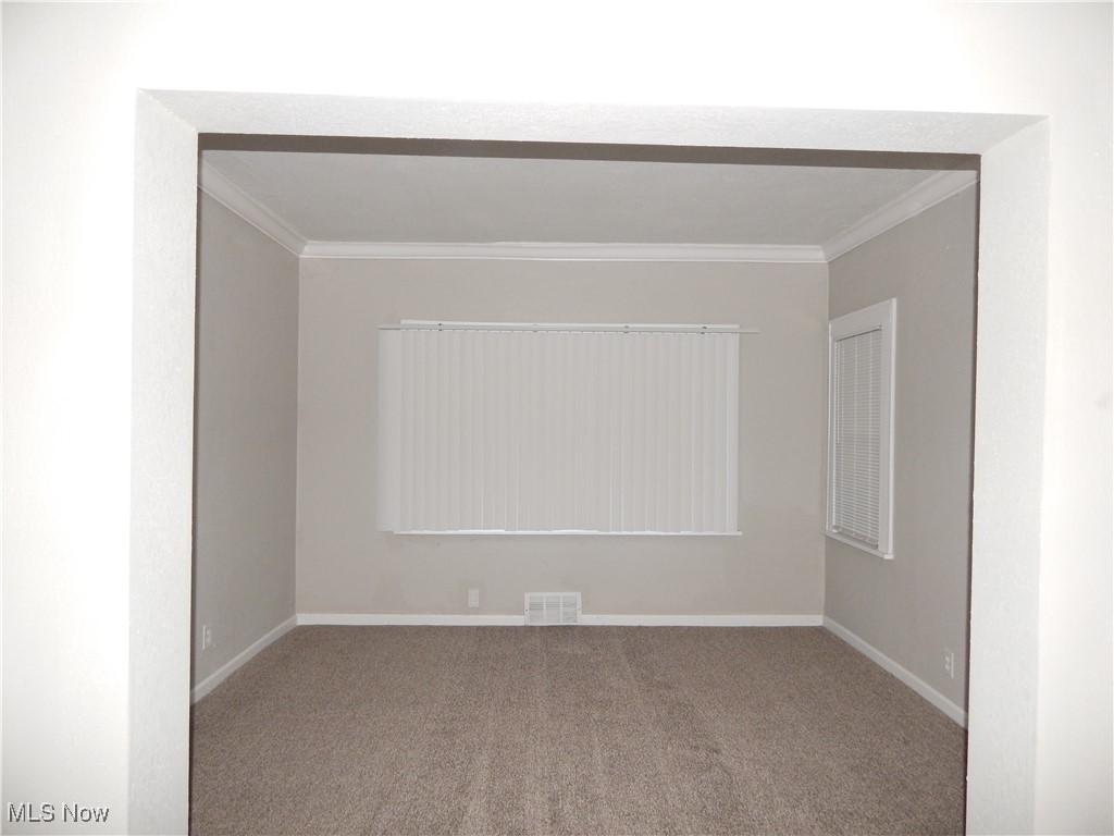 3845 Summit Park Road Cleveland Heights, OH 44121 - Photo 5 of 15 Family room with ornamental molding, visible vents, and baseboards