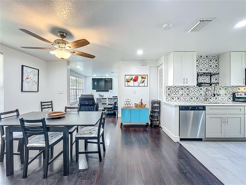 4760 Ivan Street Cocoa, FL 32927 - Photo 14 of 53 a kitchen with a table chairs and white cabinets