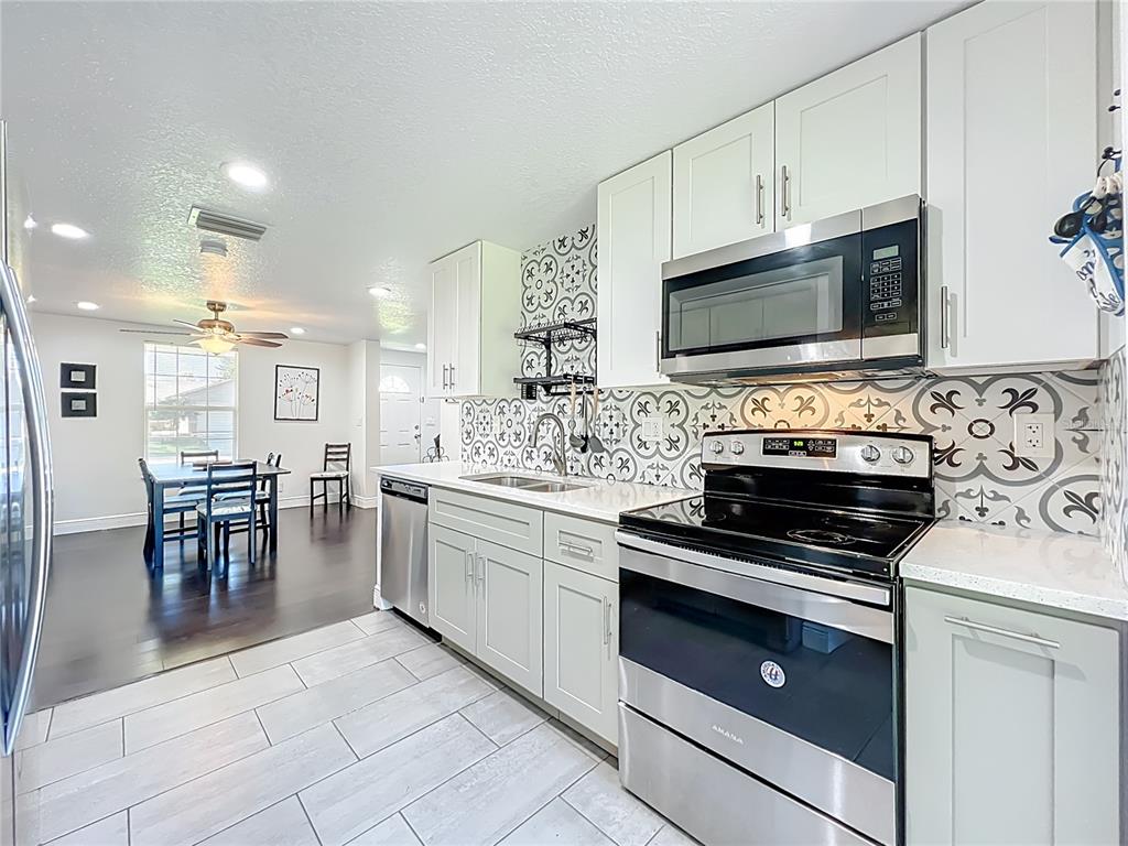 4760 Ivan Street Cocoa, FL 32927 - Photo 15 of 53 a kitchen with cabinets appliances and a counter top space