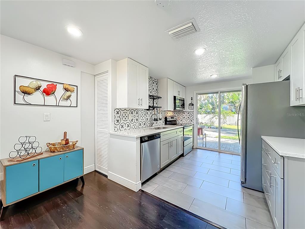 4760 Ivan Street Cocoa, FL 32927 - Photo 18 of 53 a kitchen with granite countertop a stove a chimney a sink and cabinets