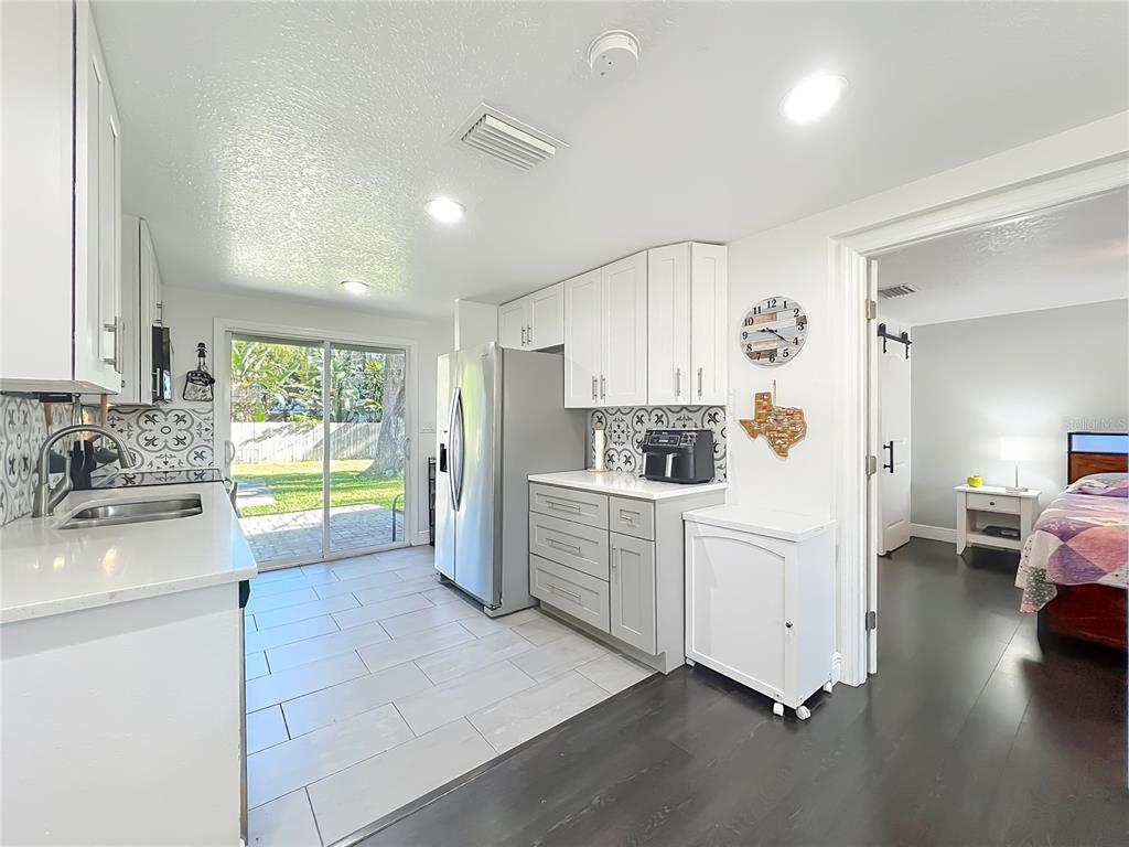4760 Ivan Street Cocoa, FL 32927 - Photo 19 of 53 a kitchen with a sink dishwasher a stove and white cabinets with wooden floor