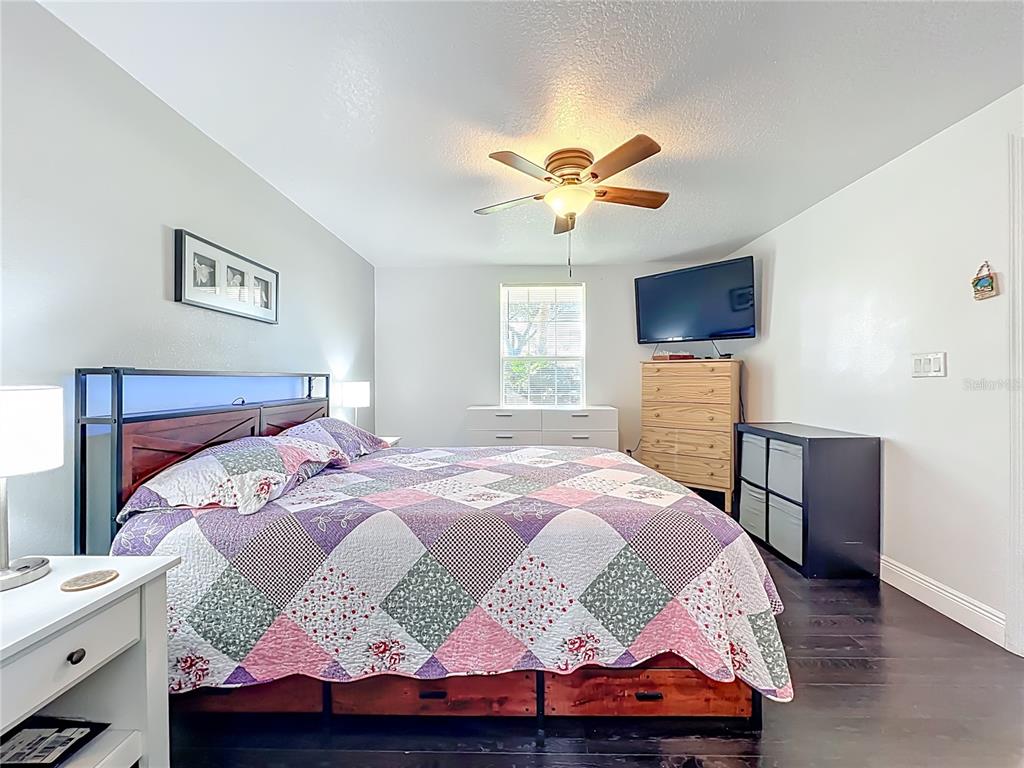 4760 Ivan Street Cocoa, FL 32927 - Photo 24 of 53 a bedroom with a bed and wooden floor