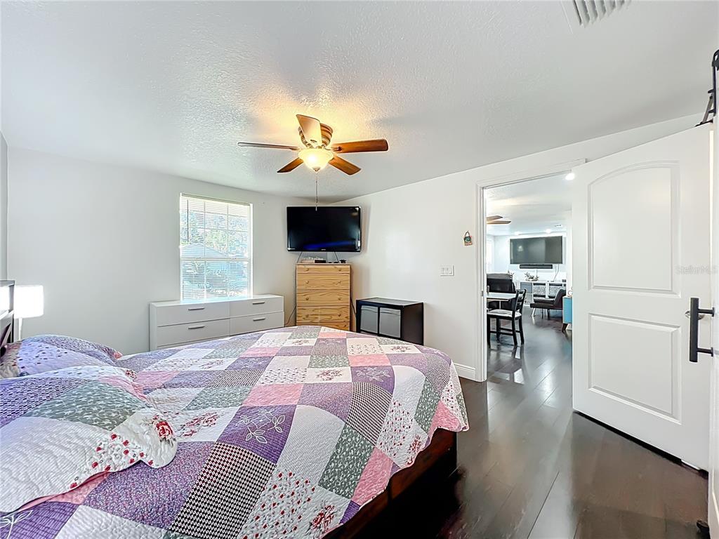 4760 Ivan Street Cocoa, FL 32927 - Photo 25 of 53 a bedroom with a bed and a chandelier