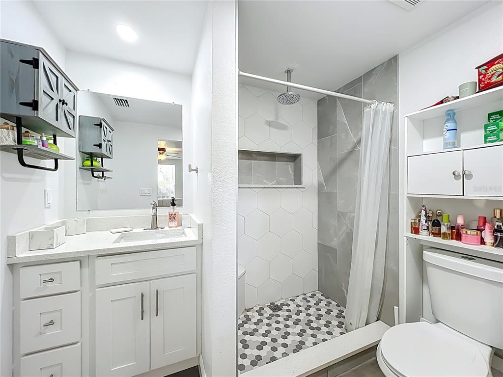 4760 Ivan Street Cocoa, FL 32927 - Photo 27 of 53 a bathroom with a sink a toilet and shower