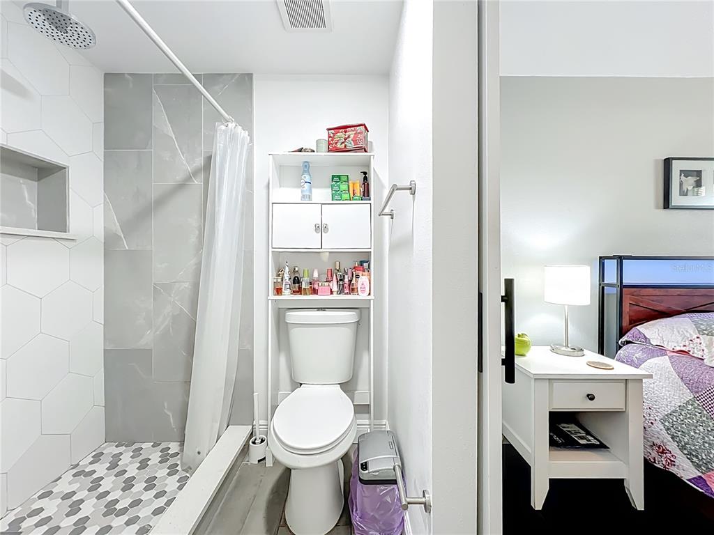 4760 Ivan Street Cocoa, FL 32927 - Photo 28 of 53 a bathroom with a toilet and a shower curtain