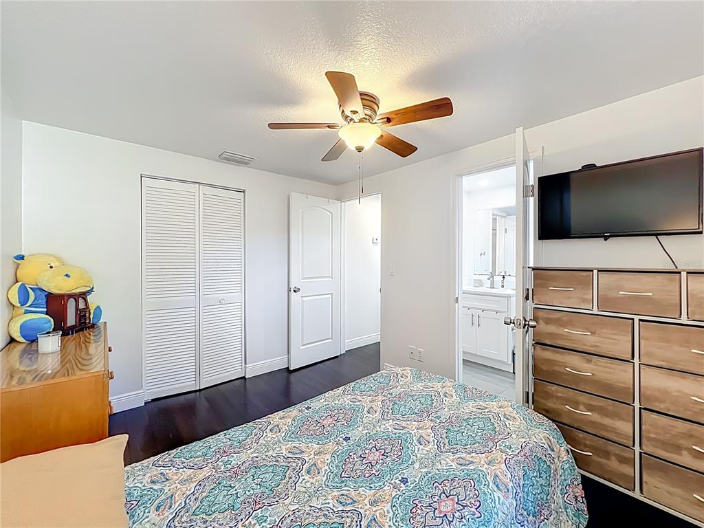 4760 Ivan Street Cocoa, FL 32927 - Photo 33 of 53 a bedroom with a bed and a flat tv screen on the dresser