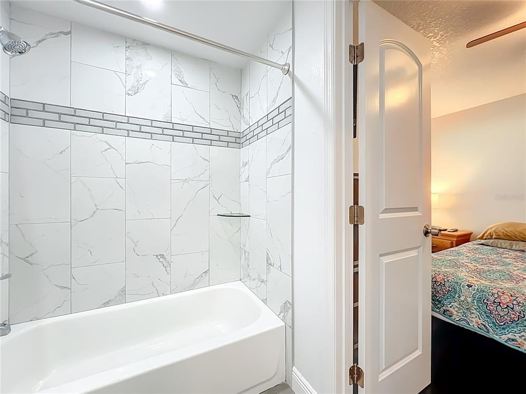 4760 Ivan Street Cocoa, FL 32927 - Photo 34 of 53 a bathroom with a bathtub and a shower