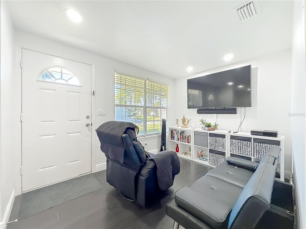 4760 Ivan Street Cocoa, FL 32927 - Photo 7 of 53 a living room with furniture and a flat screen tv