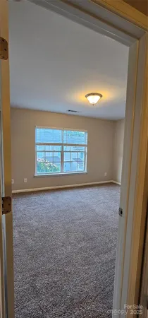 an empty room with a empty space and windows