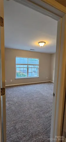 an empty room with a empty space and windows