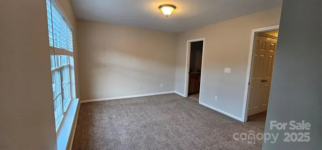 an empty room with windows and entrance