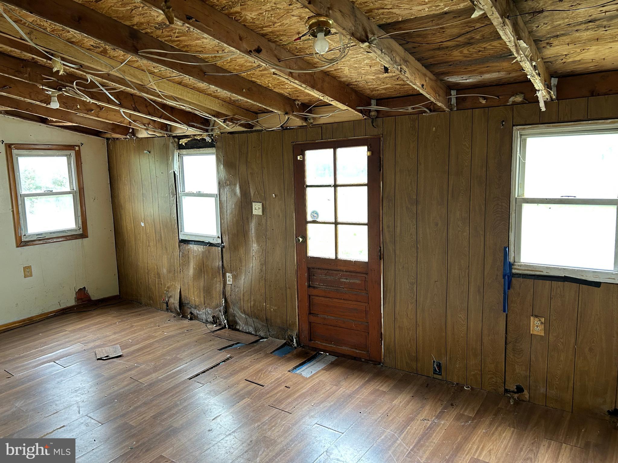 12632 Creagerstown Road Thurmont, MD 21788 - Photo 11 of 16 an empty room with wooden floor and windows
