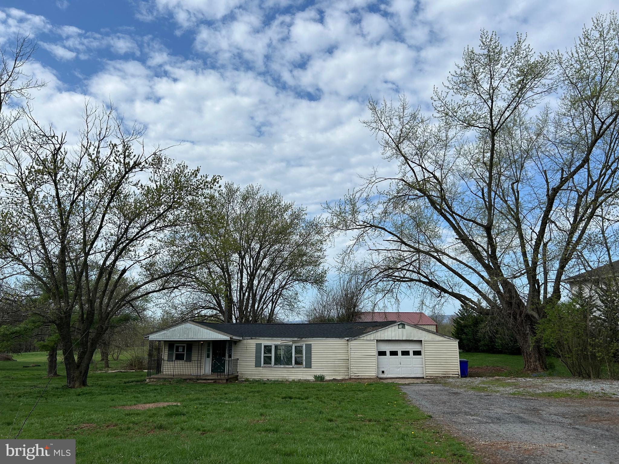 12632 Creagerstown Road Thurmont, MD 21788 - Photo 2 of 18 a view of house with yard and trees in the background