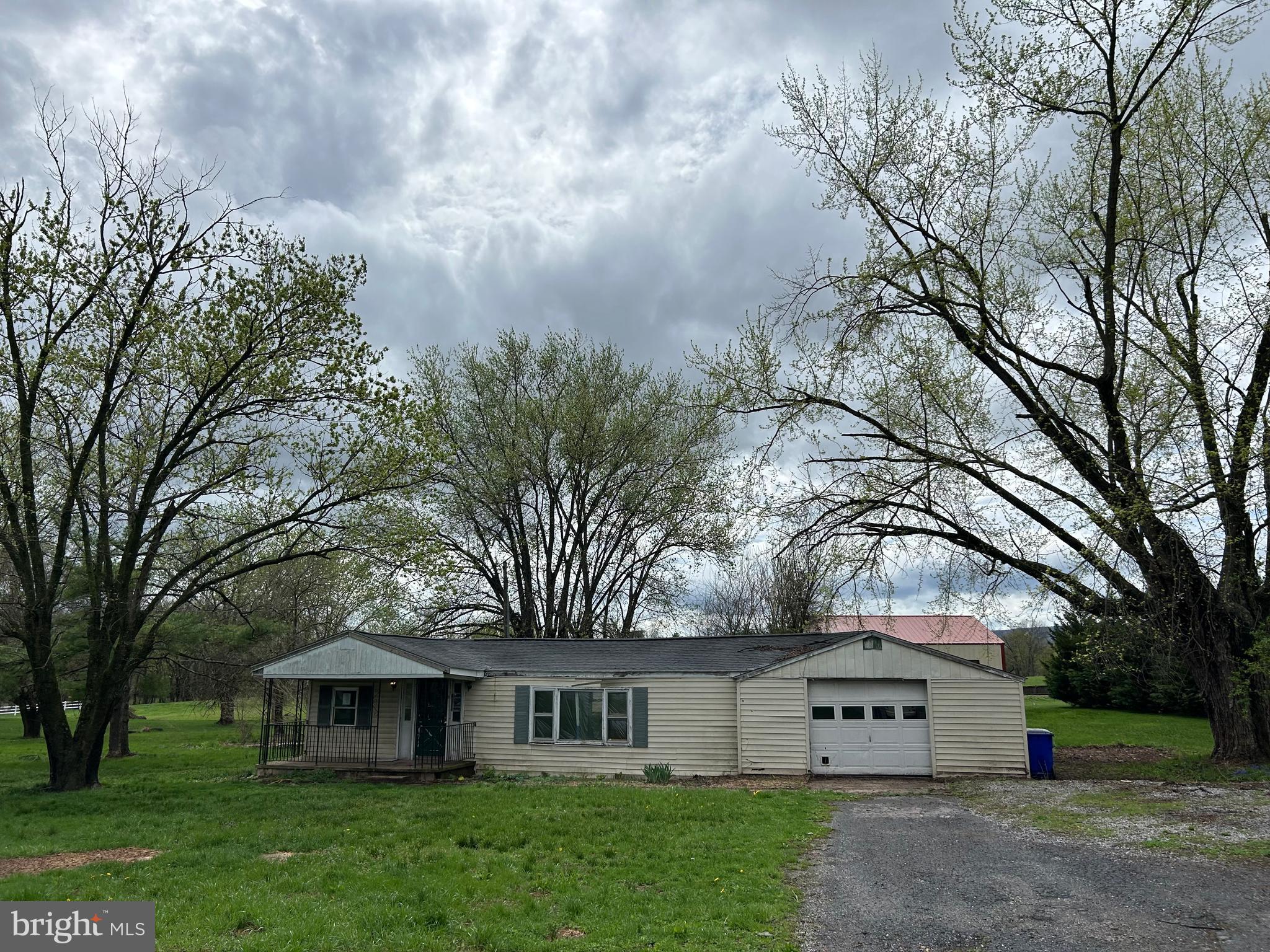 12632 Creagerstown Road Thurmont, MD 21788 - Photo 2 of 16 a front view of a house with a yard and trees