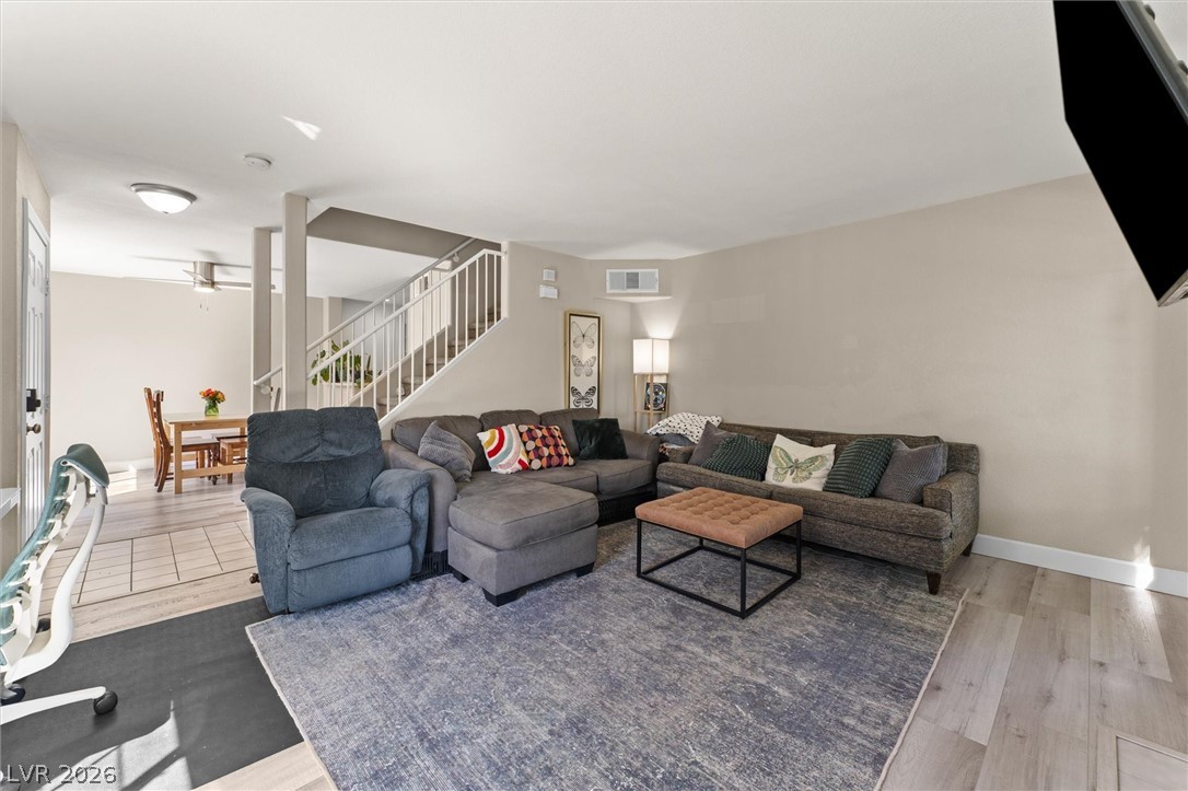 503 Rafkin Place Henderson, NV 89052 - Photo 5 of 18 An inviting gathering space seamlessly connects living and dining areas, with a staircase leading to upper levels.