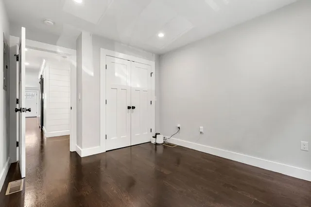 an empty room with wooden floor