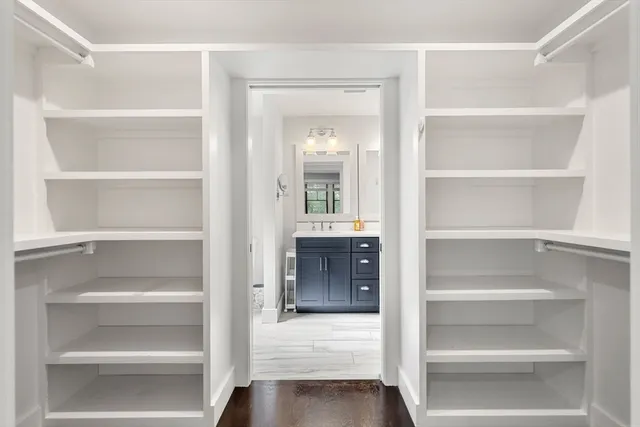 a view of walk in closet with empty racks