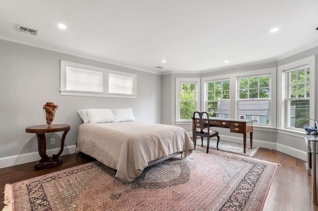 15 Parker Road Needham, MA 02494 - Photo 24 of 41 a spacious bedroom with a bed and a table in it