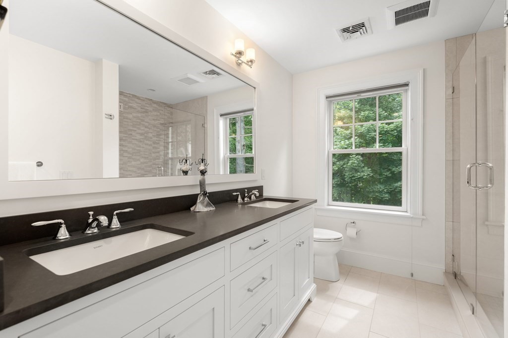 15 Parker Road Needham, MA 02494 - Photo 25 of 41 a bathroom with a sink double vanity and a window