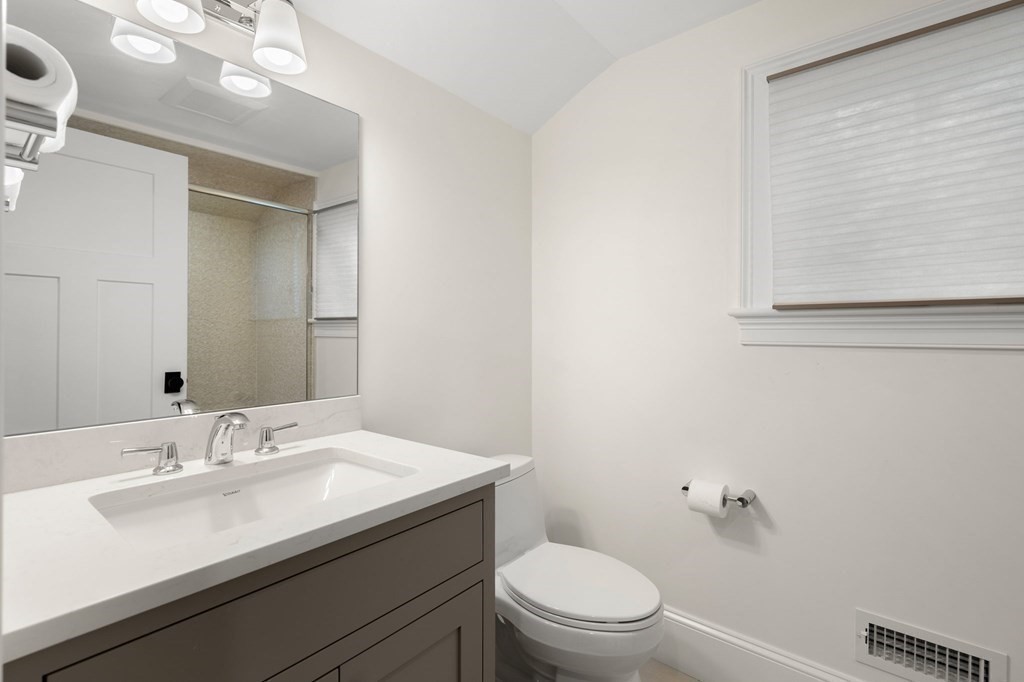 15 Parker Road Needham, MA 02494 - Photo 29 of 41 a bathroom with a sink a toilet and a mirror