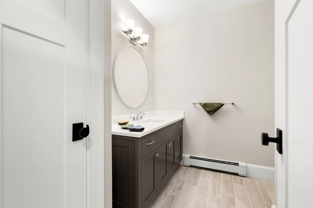 15 Parker Road Needham, MA 02494 - Photo 34 of 41 a bathroom with a sink a mirror and shower view