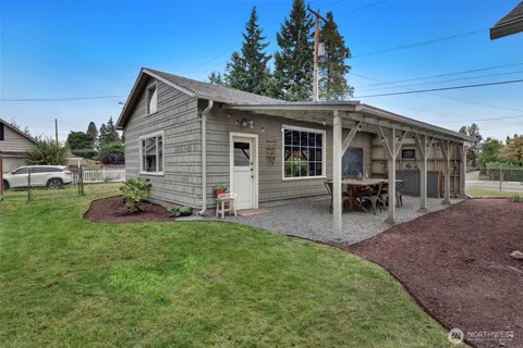 a view of a house with backyard porch and sitting area