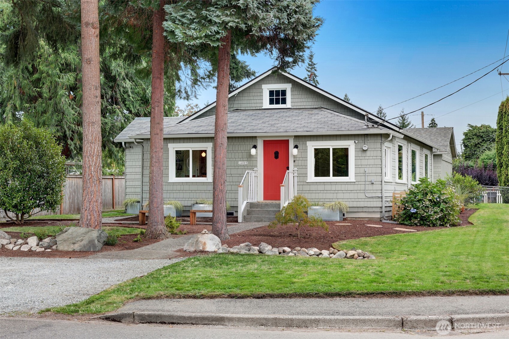 16003 15th Avenue Southwest Burien, WA 98166 - Photo 13 of 36 a front view of a house with a yard