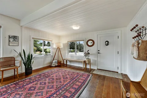 a living room with furniture rug and window